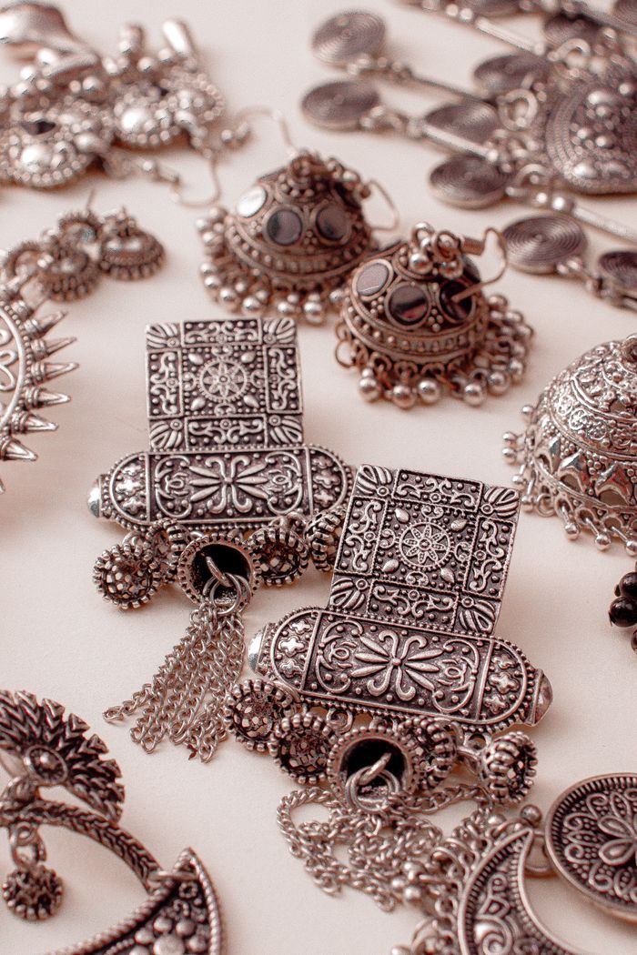 Services Detailed close-up of traditional silver jewelry with intricate designs from Dhaka, Bangladesh.